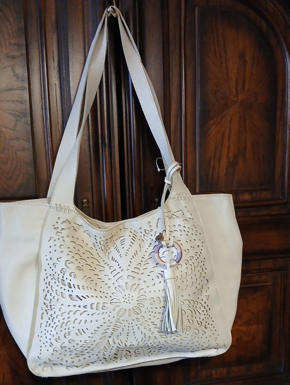 The Sak Cream Laser-Cut Floral Tote with Tassel Charm